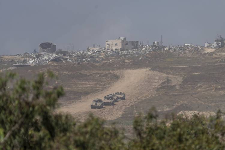 Israeli armored personnel carriers move near the Israeli-Gaza border as seen from southern Israel, Wednesday, April 17, 2024.